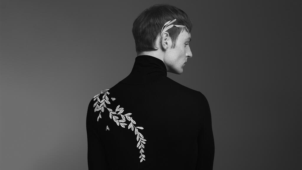 The “Airelles” necklace, which translates to “lingonberries,” features pavé diamonds set in white gold (all pieces are price upon request). Here the piece has been transformed from a necklace into a brooch, draping down the model’s shoulder. A “Mouche” fly brooch has also landed on his back. Boucheron Airelles Necklace Brooch